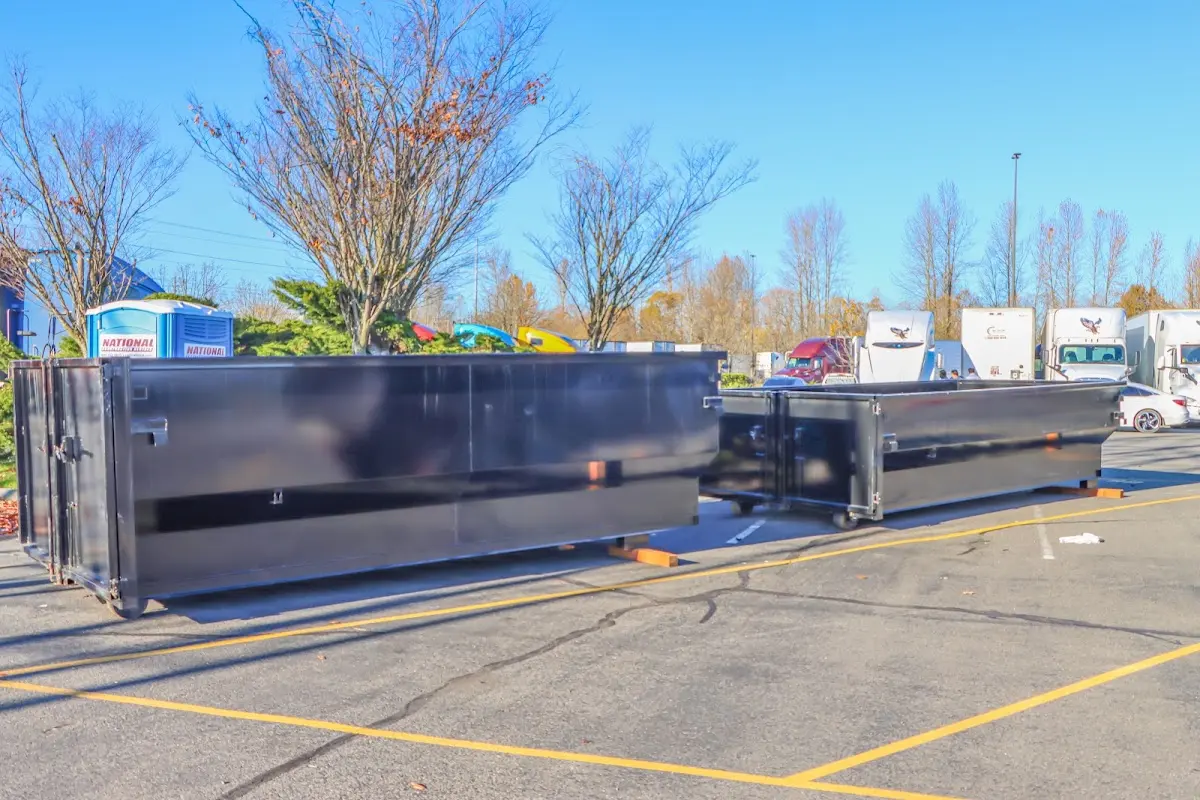 Professional dumpster rental service with roll-off container on residential driveway in University City